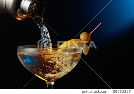 Martini with green olives and lemon. 89983257