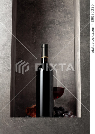 Bottle and glass of red wine with blue grapes. Bottle and glass of red wine with blue grapes. 89983359