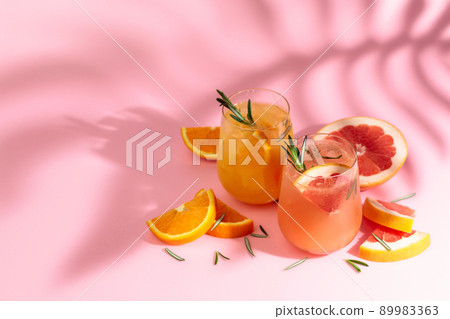Summer cocktails with grapefruit, orange, rosemary, and ice. Summer cocktails with grapefruit, orange, rosemary, and ice. 89983363