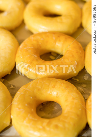 assorted donuts with chocolate frosted, pink glazed and sprinkles donuts. assorted donuts with chocolate frosted, pink glazed and sprinkles donuts. 89983665