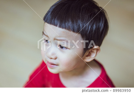 Close up of Little caucasian boy in a red T-shirt feel upset,angry. Close up of Little caucasian boy in a red T-shirt feel upset,angry. 89983950