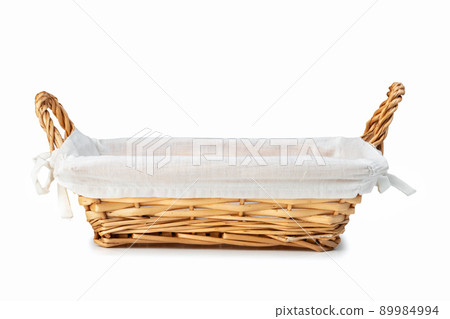 Empty wicker bread basket with white napkin isolated on white Empty wicker bread basket with white napkin isolated on white 89984994