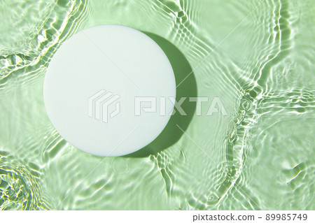 Empty white circle podium on transparent green clear water background Empty white circle podium on transparent green clear water background 89985749