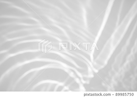 blurred shadow and light caustic effect on a white wall blurred shadow and light caustic effect on a white wall 89985750