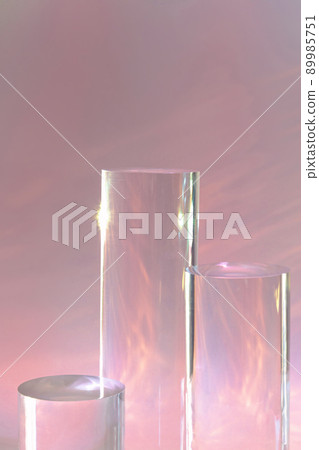 three clear glass cylinder podiums on pastel pink background three clear glass cylinder podiums on pastel pink background 89985751