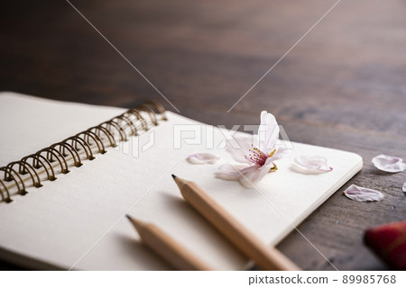 Cherry petals and ring notes and pencils 89985768