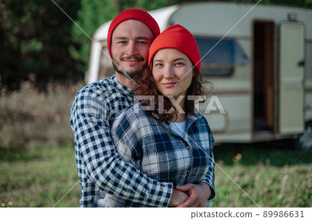 Romantic couple spending time together near trailer home. Romantic couple spending time together near trailer home. 89986631
