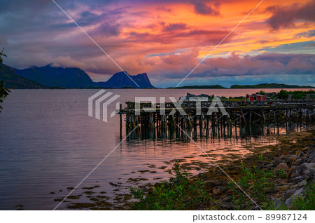 Colorful sunset over a Wooden jetty on Senja Island in Norway Colorful sunset over a Wooden jetty on Senja Island in Norway 89987124
