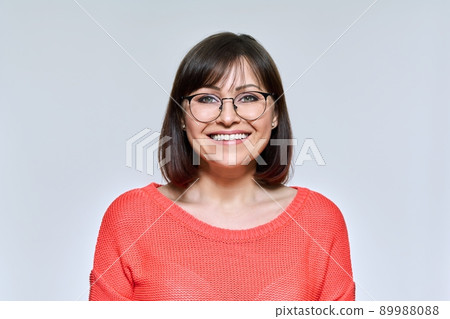 Headshot of smiling middle aged woman looking at camera Headshot of smiling middle aged woman looking at camera 89988088