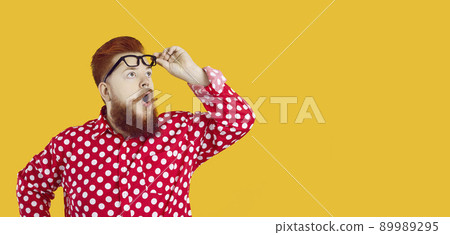 Funny charismatic chubby man with shocked expression looks at copy space on yellow background. Funny charismatic chubby man with shocked expression looks at copy space on yellow background. 89989295