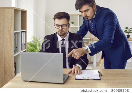Serious lawyers are working on lawsuit using laptop and Internet to search for case data. Serious lawyers are working on lawsuit using laptop and Internet to search for case data. 89989308