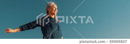 Adult slender woman standing by the waterfront 89989807