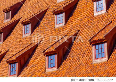 Many small windows on a red roof covered with tiles in the old town of Gdansk 89990226