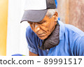 old afro american man sitting outdoors 89991517