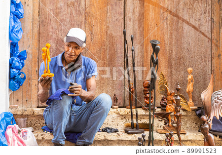 old afro american street artist showing his wooden sculpture old afro american street artist showing his wooden sculpture 89991523