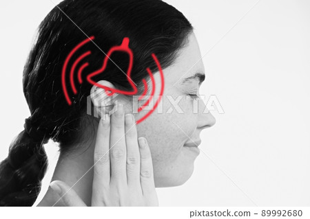 Tinnitus. A dissatisfied young woman holds her hand over her ears, experiencing ringing and pain. The concept of ear diseases and deafness 89992680