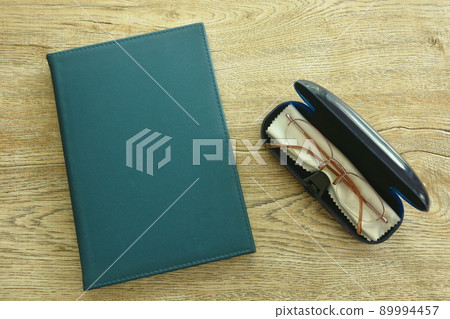 longsighted prescription glasses in box with book on table 89994457