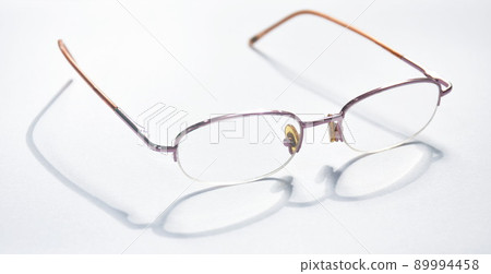 longsighted prescription glasses with shadow arranging on white background 89994458