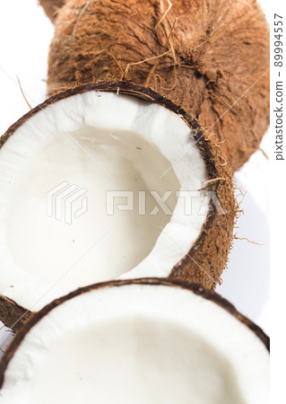 Closeup of Cracked fresh coconuts on white background 89994557