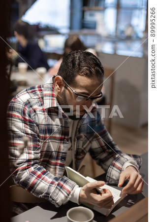 Middle Eastern man twilight alone in a cafe Middle Eastern man twilight alone in a cafe 89995266