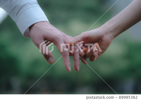 Male and female joining hands Male and female joining hands 89995362