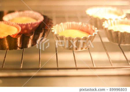 Homemade sweet muffin baking in a molds in oven 89996803