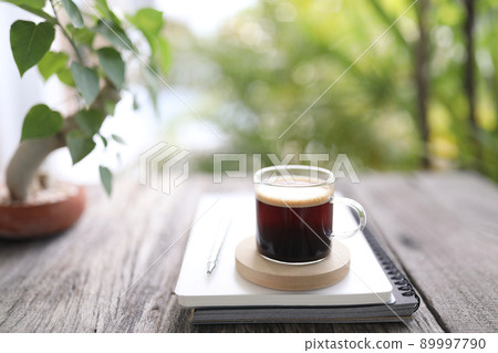 Americano coffee glass cup and notebooks Americano coffee glass cup and notebooks 89997790