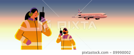 airport workers marshallers communicating over walkie-talkie with air traffic control while airplane flying in sky professional airport staff airport workers marshallers communicating over walkie-talkie with air traffic control while airplane flying in sky professional airport staff 89998002