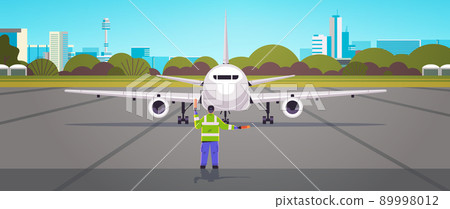 aviation marshaller supervisor in uniform signaling near aircraft air traffic controller airline worker in signal vest professional airport staff 89998012