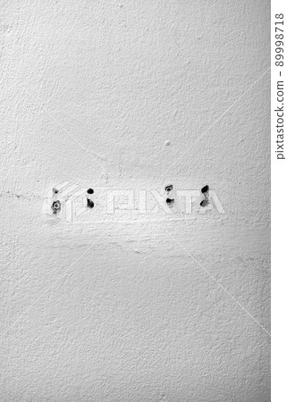 Hole and dowels in an old dirty white wall. Hole and dowels in an old dirty white wall. 89998718