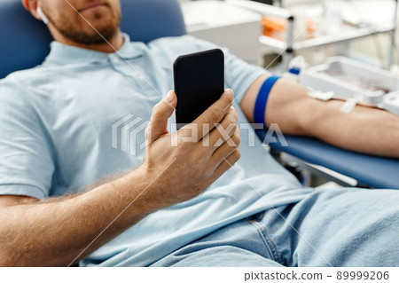 Man Watching Videos in Blood Donation Man Watching Videos in Blood Donation 89999206