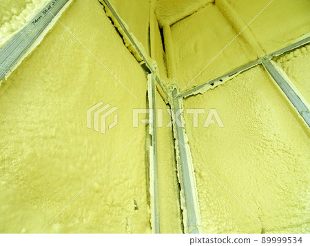 SELANGOR, MALAYSIA - MARCH 10, 2022: Polyurethane insulating foam that has been sprayed and covered the concrete slabs and walls surface. Serves as a layer of thermal insulation for the building. SELANGOR, MALAYSIA - MARCH 10, 2022: Polyurethane insulating foam that has been sprayed and covered the concrete slabs and walls surface. Serves as a layer of thermal insulation for the building. 89999534