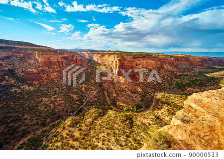 Large open canyon in desert with red cliffs and small river Large open canyon in desert with red cliffs and small river 90000513