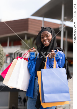 Merry Muslim shopaholic with colorful paper bags 90001751