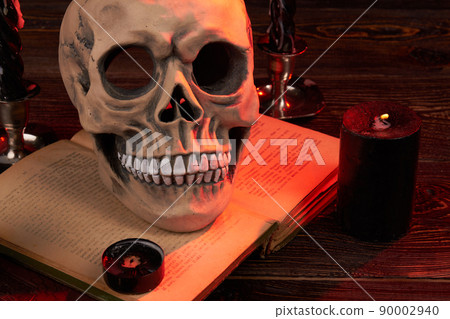 Wicca satanic ritual concept. Humans skull on the satanic bible book. Wicca satanic ritual concept. Humans skull on the satanic bible book. 90002940