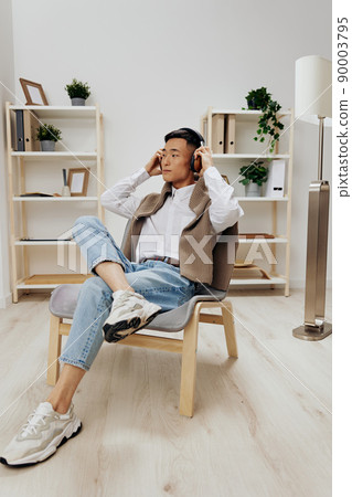 man in headphones sits on a chair rest music Lifestyle man in headphones sits on a chair rest music Lifestyle 90003795