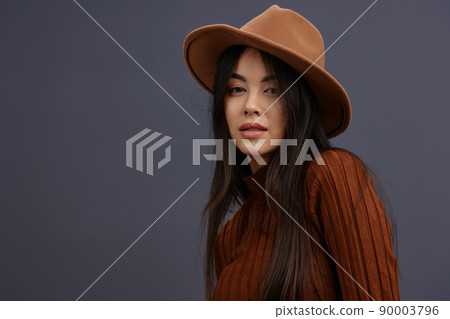 Brunette brown hat hand gestures brown sweater fashion emotions Gray background Brunette brown hat hand gestures brown sweater fashion emotions Gray background 90003796