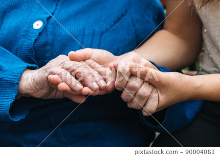 Charities for Elderly People. Young hands holding old elderly senior hands. Support for the seniors concept. 90004081