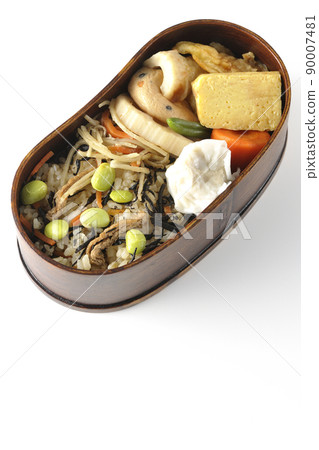 A bird's-eye view of the Makunouchi lunch box containing a lot of side dishes such as hijiki and edamame rice, shumai, omelet, and simmered dishes. A bird's-eye view of the Makunouchi lunch box containing a lot of side dishes such as hijiki and edamame rice, shumai, omelet, and simmered dishes. 90007481