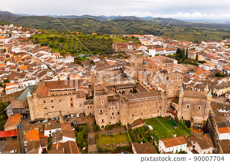 Aerial view of ancient Monastery of Guadalupe surrounded by residential buildings Aerial view of ancient Monastery of Guadalupe surrounded by residential buildings 90007704