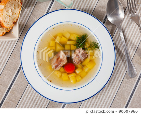 Rustic style soup in meat stock with pork and vegetables Rustic style soup in meat stock with pork and vegetables 90007960