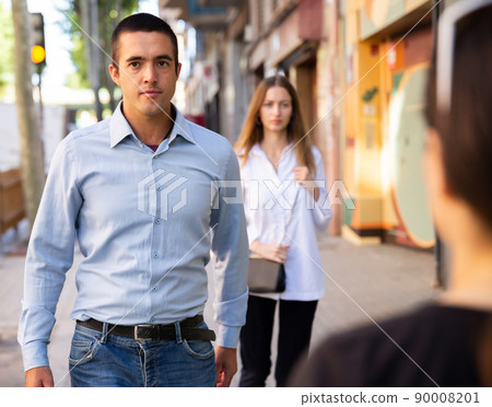 Confident man walking through city streets in spring 90008201