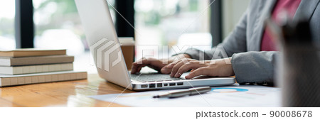 Business analyst concept the female officer typing financial information on the computer laptop Business analyst concept the female officer typing financial information on the computer laptop 90008678