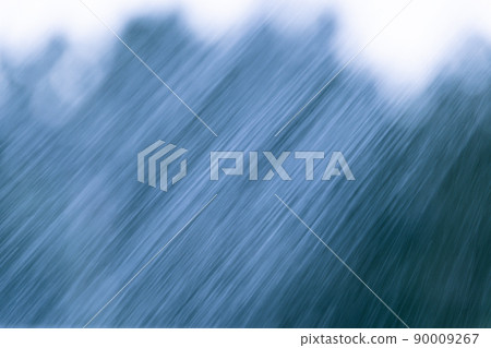 Jets of water and drops against backdrop of silhouette of trees. Watering in summer garden. Irrigation of plants, cool freshness of humidity 90009267