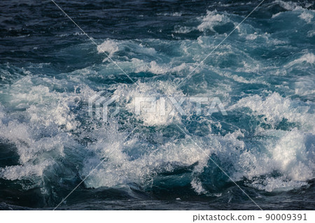 Turquoise ocean waves as backdrop. Sea water boils and foams during surf. Mountain blue river with fast current Turquoise ocean waves as backdrop. Sea water boils and foams during surf. Mountain blue river with fast current 90009391