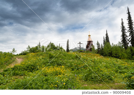 Golden domes of Orthodox Church and cross in taiga forest. Appeal to God, prayer before difficult tourist route. Salvation of soul in pristine nature 90009408