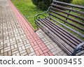 Wooden bench in autumn park after rain. Place of breath of townspeople. Walk in fresh air on cloudy day 90009455
