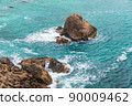 Sea surf, turquoise ocean waves beat against rocky shore. High tide time, water foams and splashes. Holidays in warm tropical regions 90009462
