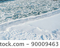 Arctic winter landscape in frozen bay. Floating ice floes in river on white frost bank. Beginning of glaze drift in reservoir, risk of navigation for vessel 90009463