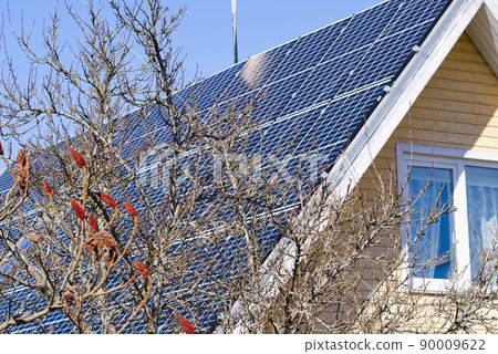 Single family house with solar system or photovoltaic system. Solar Panels on Roof of Home Single family house with solar system or photovoltaic system. Solar Panels on Roof of Home 90009622